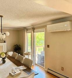 Wall-mounted ductless heat pump in Shirley, MA living room.