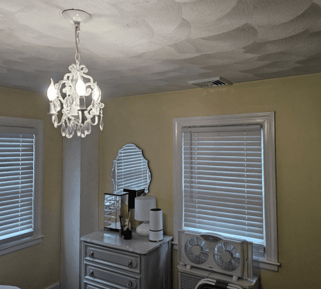 Newly installed ductwork in yellow bedroom in Worcester, MA home.