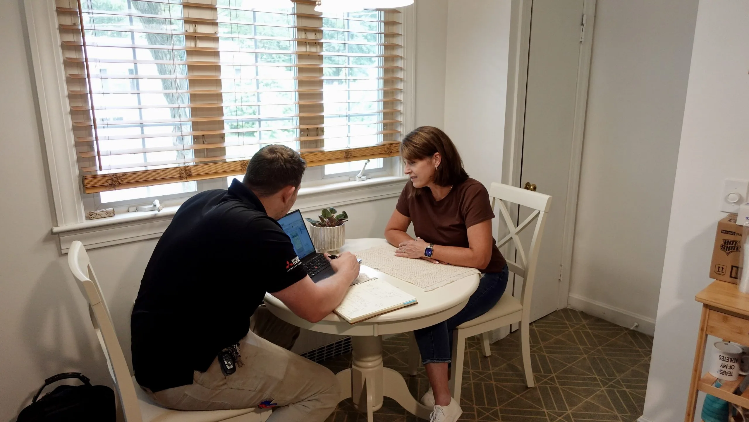 Jay Moody HVAC engineer sitting down with homeowner to design HVAC system.