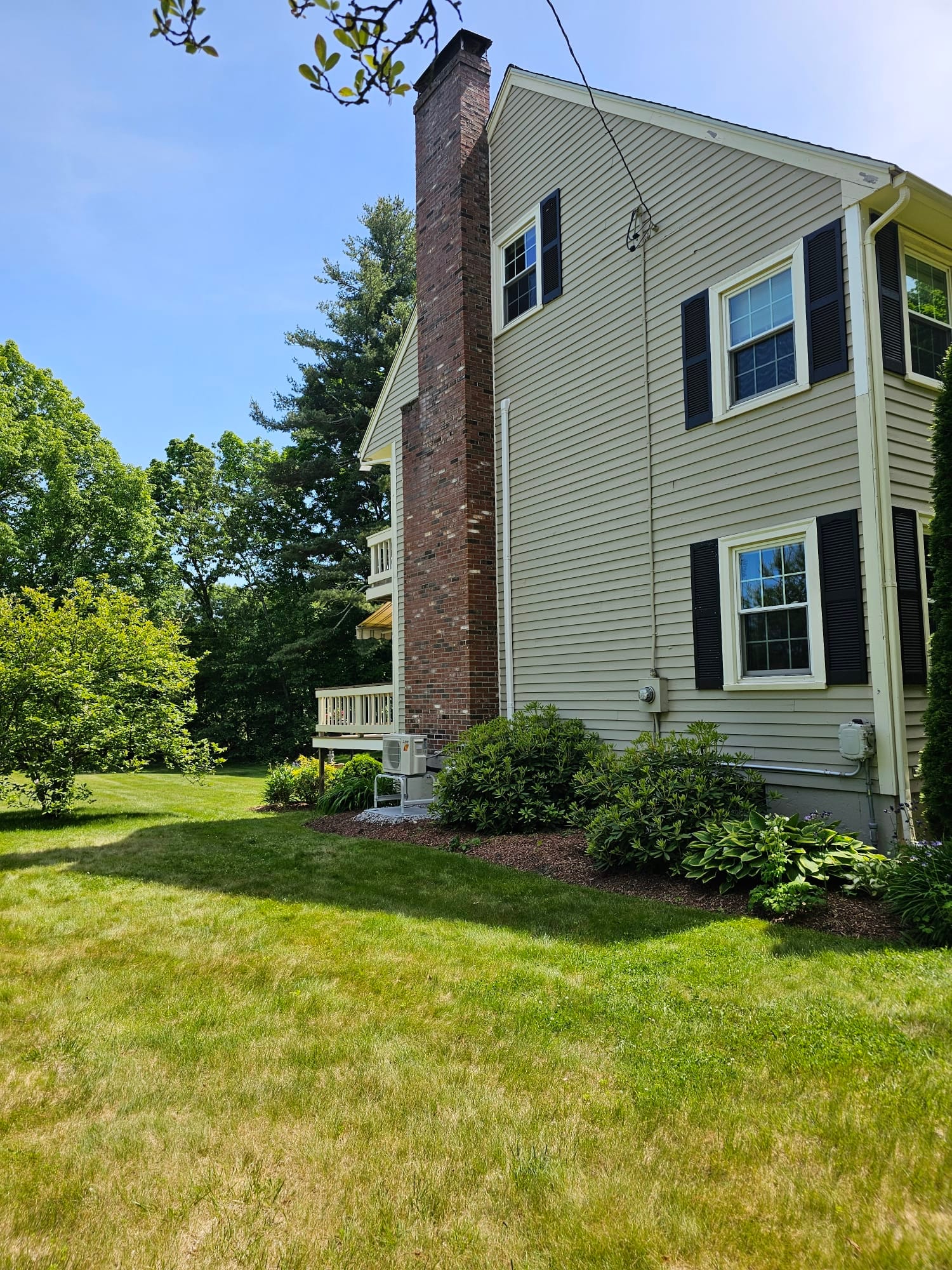 Outdoor Mitsubishi mini-split unit for Shirley, Massachusetts home.