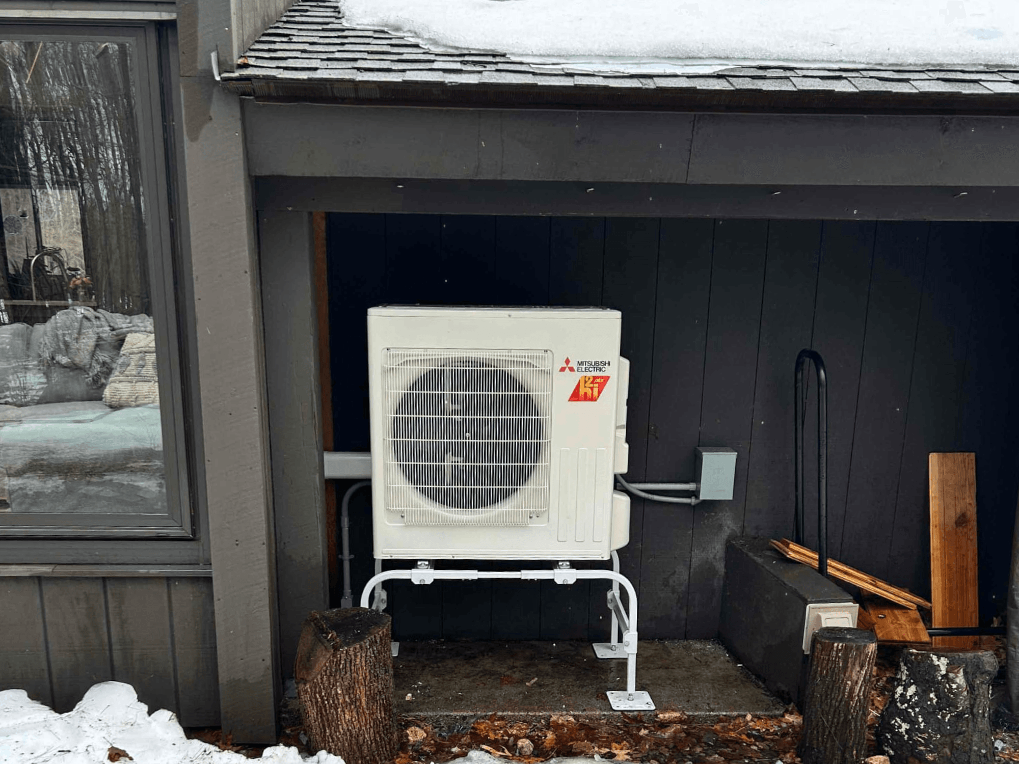 Mitibishi outdoor condensor located at the back of a home in Westminster, Massachusetts.