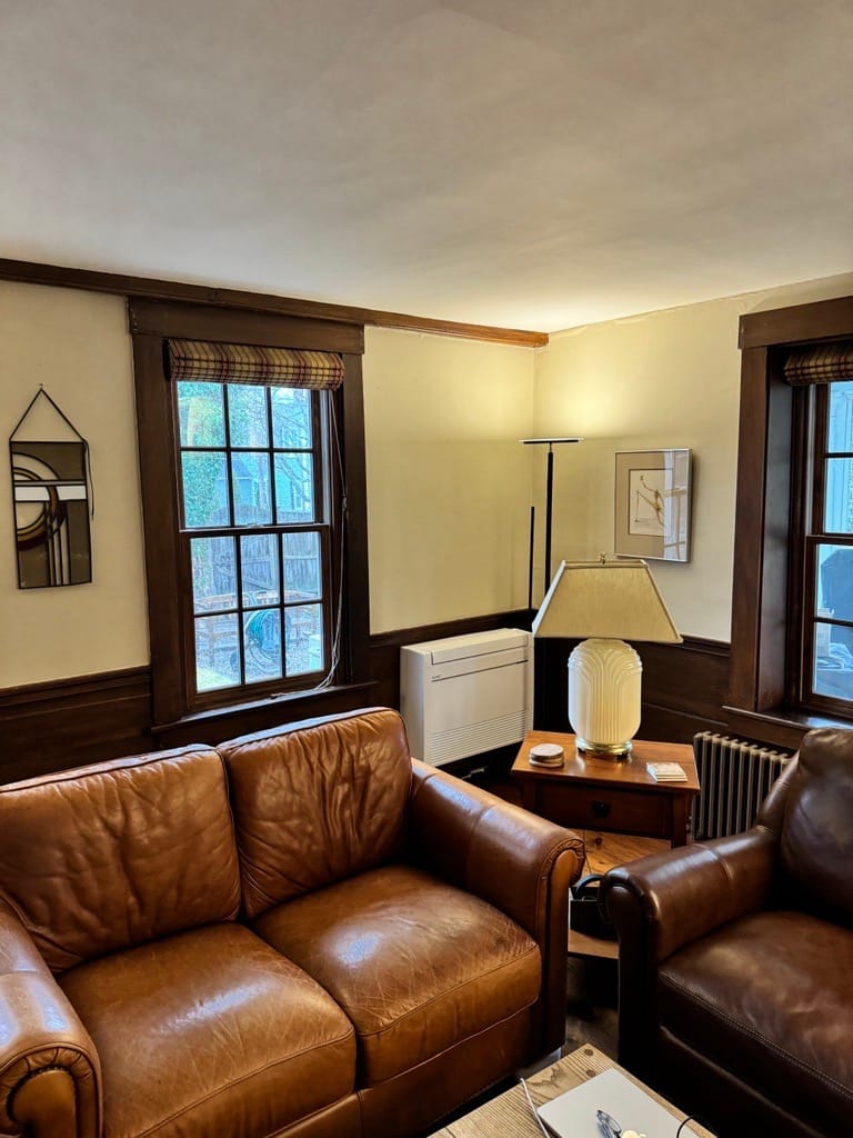 Mitsubishi ductless heta pump mounted on floor of living room in historic home located in Harvard, MA
