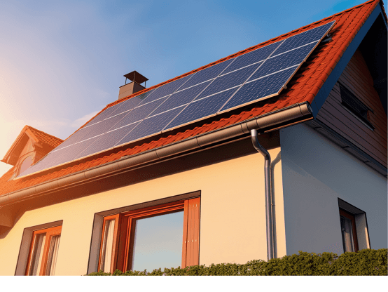 Solar panels on roof of home with sun in background.